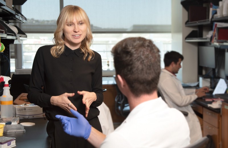 Krystal Fontaine talking to another scientist in the lab