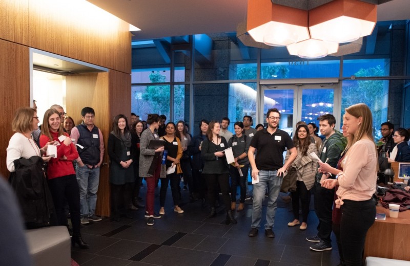 Group of people gathering in a circle in the Gladstone lobby