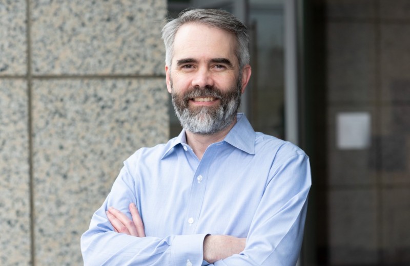 Alex Pico with his arms crossed outside the Gladstone building