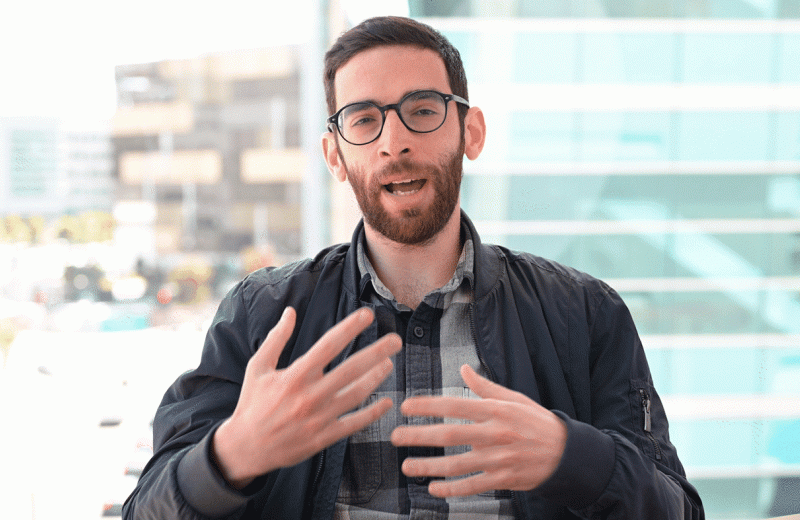 GIF of Jason Nomburg speaking with his hands in a conference room at Gladstone Institutes