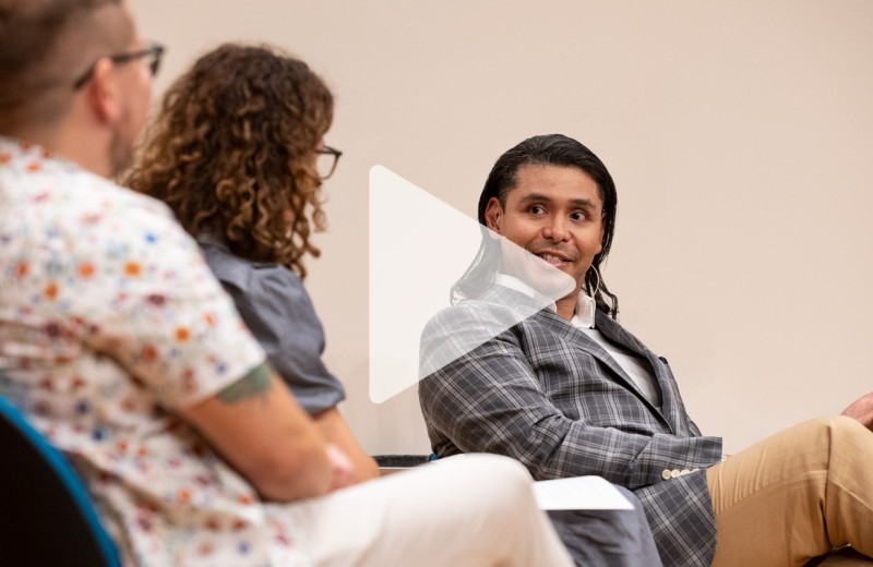 Close up of Adam Castillejo, the London Patient, with a play button over top