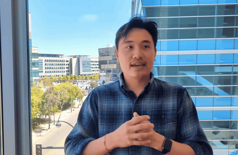 Gif of Oscar Yip sitting for an interview talking with his hands